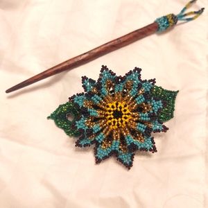 Hand beaded hair piece.